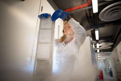 Photo of female researcher with samples in dry ice