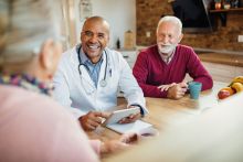 A doctor having a conversations with two people